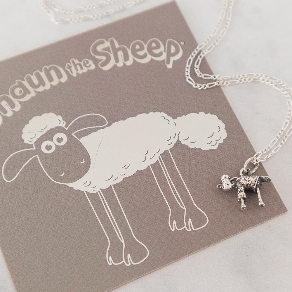 Close-up of Shaun the Sheep necklace showing detailed knitted jumper design in polished sterling silver.