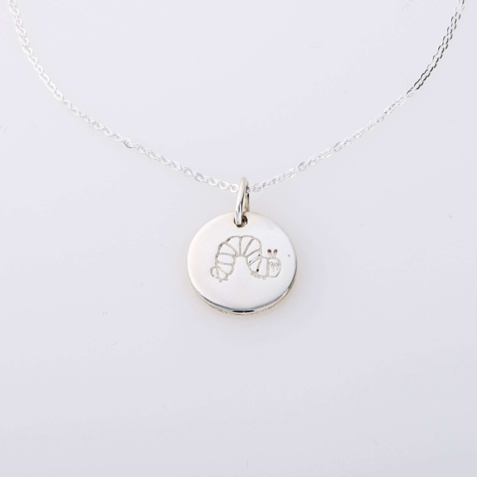 Sterling silver The Very Hungry Caterpillar Small Disc Necklace, a handmade literary-inspired pendant, perfect for mums, daughters & book lovers.