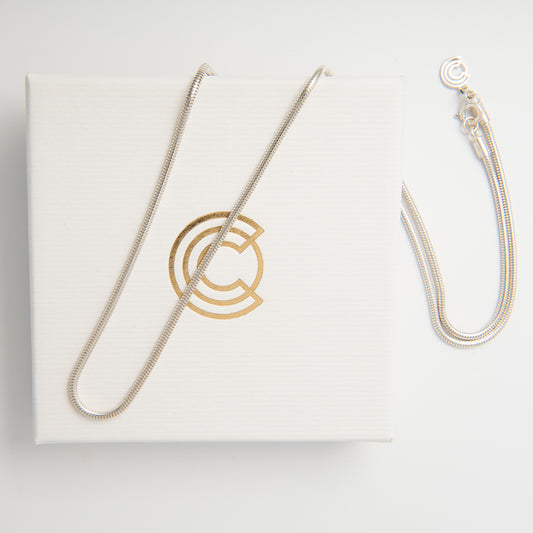 Close-up of the Sterling Silver Snake Chain Necklace highlighting the smooth, interlocked tubular links and elegant shine.