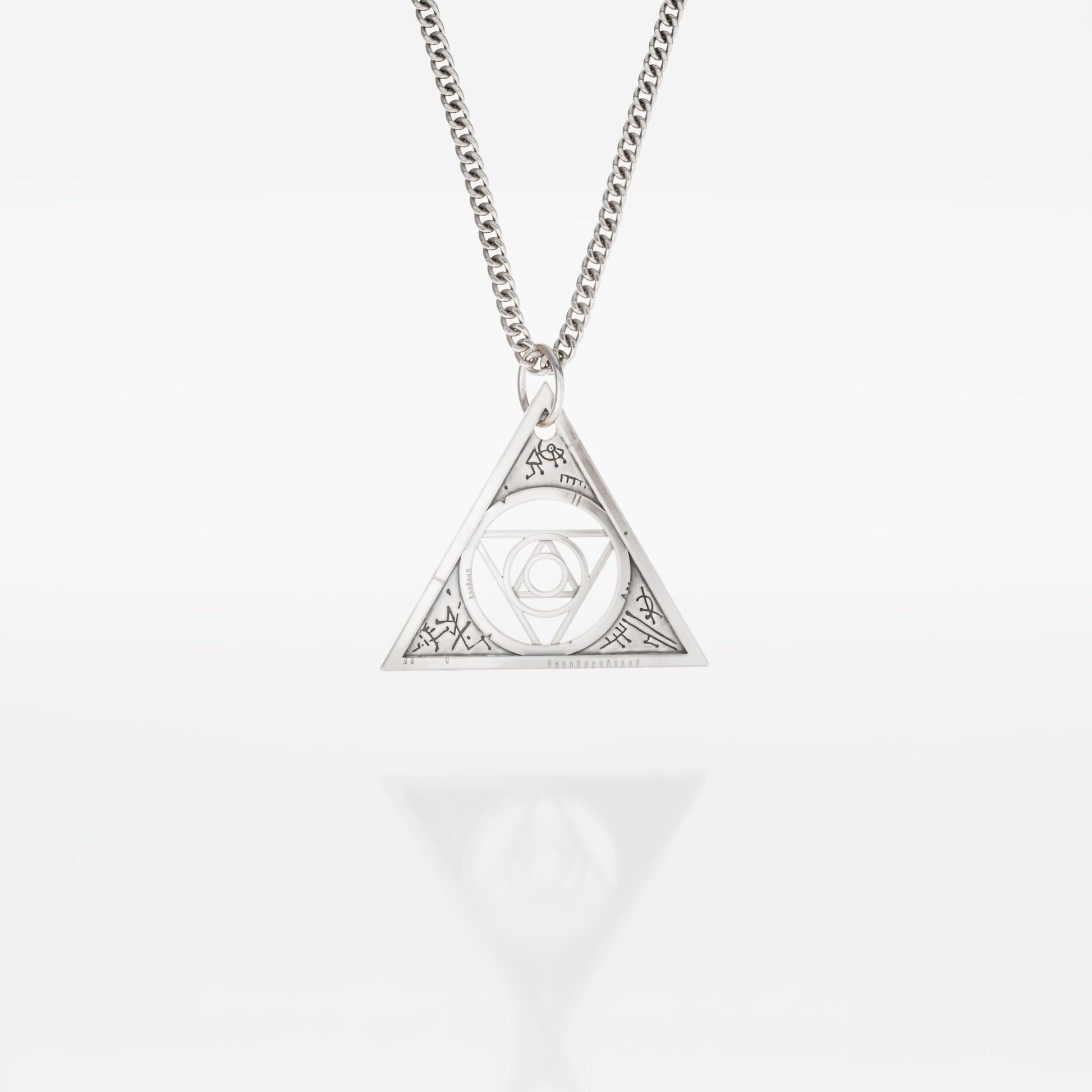 Aughra's Triangle Necklace in sterling silver, inspired by The Dark Crystal. Features the Eye of the superimposed suns within an intricate triangle design on a 45 cm trace chain. Perfect for fans of Jim Henson’s dark fantasy universe