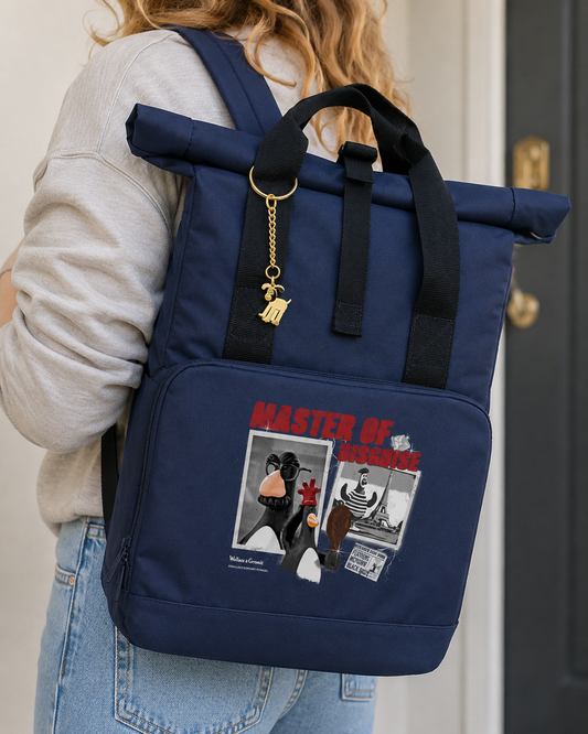 Gold Wallace & Gromit Gromit bag charm keyring attached to a navy Wallace & Gromit backpack in a lifestyle setting.