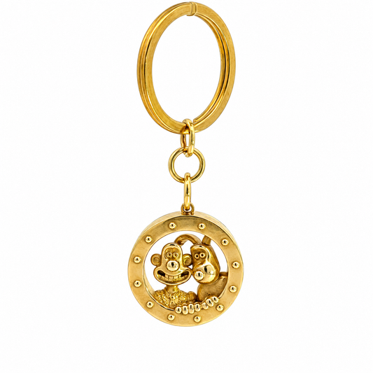 Wallace and Gromit brass porthole keyring on a white background