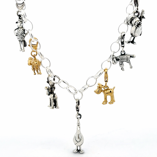 Feathers McGraw with bag sterling silver clip-on charm worn on a charm bracelet with other Wallace & Gromit character charms