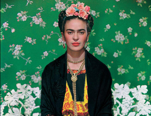 Portrait of Frida Kahlo with her signature bold eyebrows, floral headpiece, and traditional Mexican attire, symbolizing her strength, creativity, and artistic legacy