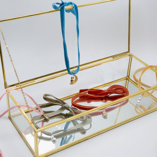 Gold Miffy jewellery display box with colourful ribbon necklaces and charms, styled for Refresh Your Jewellery 2026 trend edit