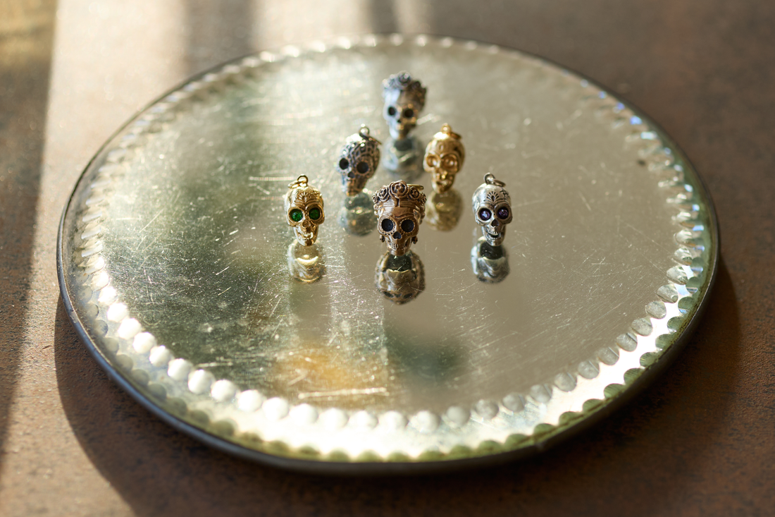 Sterling silver charm bracelet with Frida Kahlo skull charm alongside Miffy, Paddington and Gromit character charms