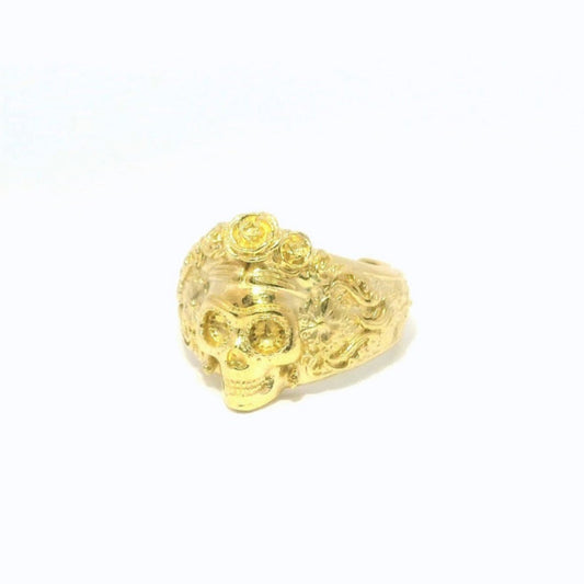 Frontal close-up of Frida Kahlo gold skull ring with detailing and ornate finish