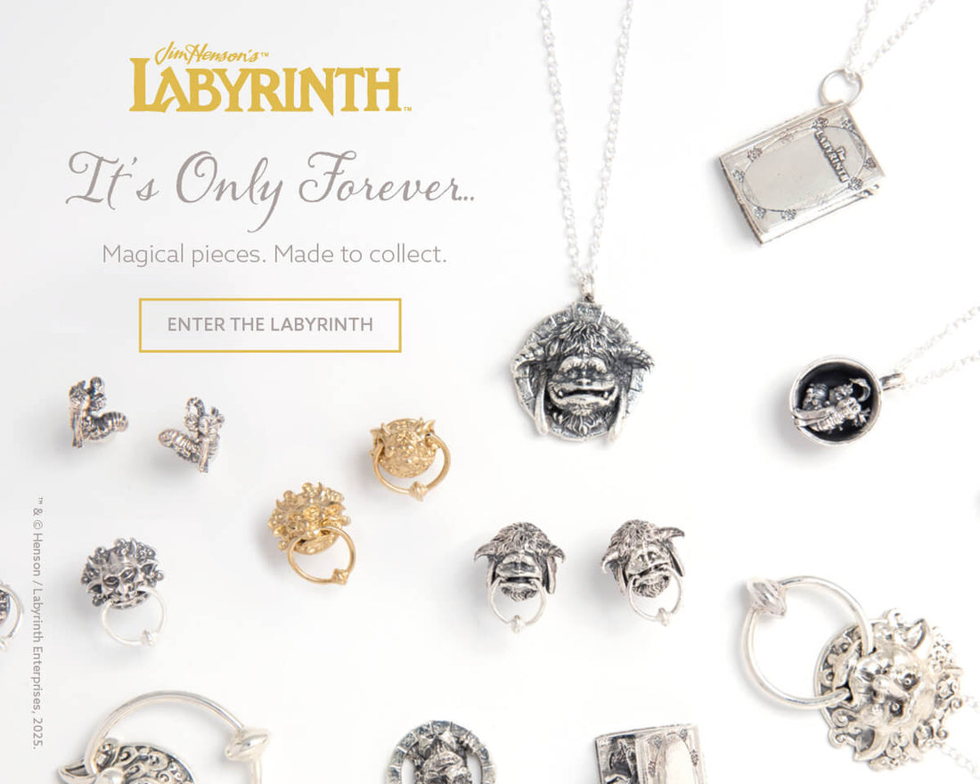 Flatlay of Licensed To Charm’s Labyrinth jewellery collection including sterling silver Door Knocker Earrings, Crystal Ball Necklace, Worm in a Cup, and Goblin-inspired charms displayed on a textured surface
