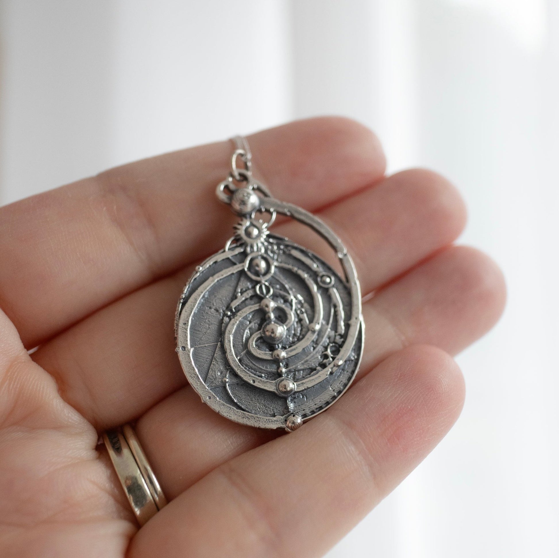 Sterling Silver Mystic Spiral Necklace, a detailed replica of the Master Time Spiral from The Dark Crystal. Captures the film’s mystical lore with its symbolic spirals and triangle design. Ideal for collectors and fantasy lovers