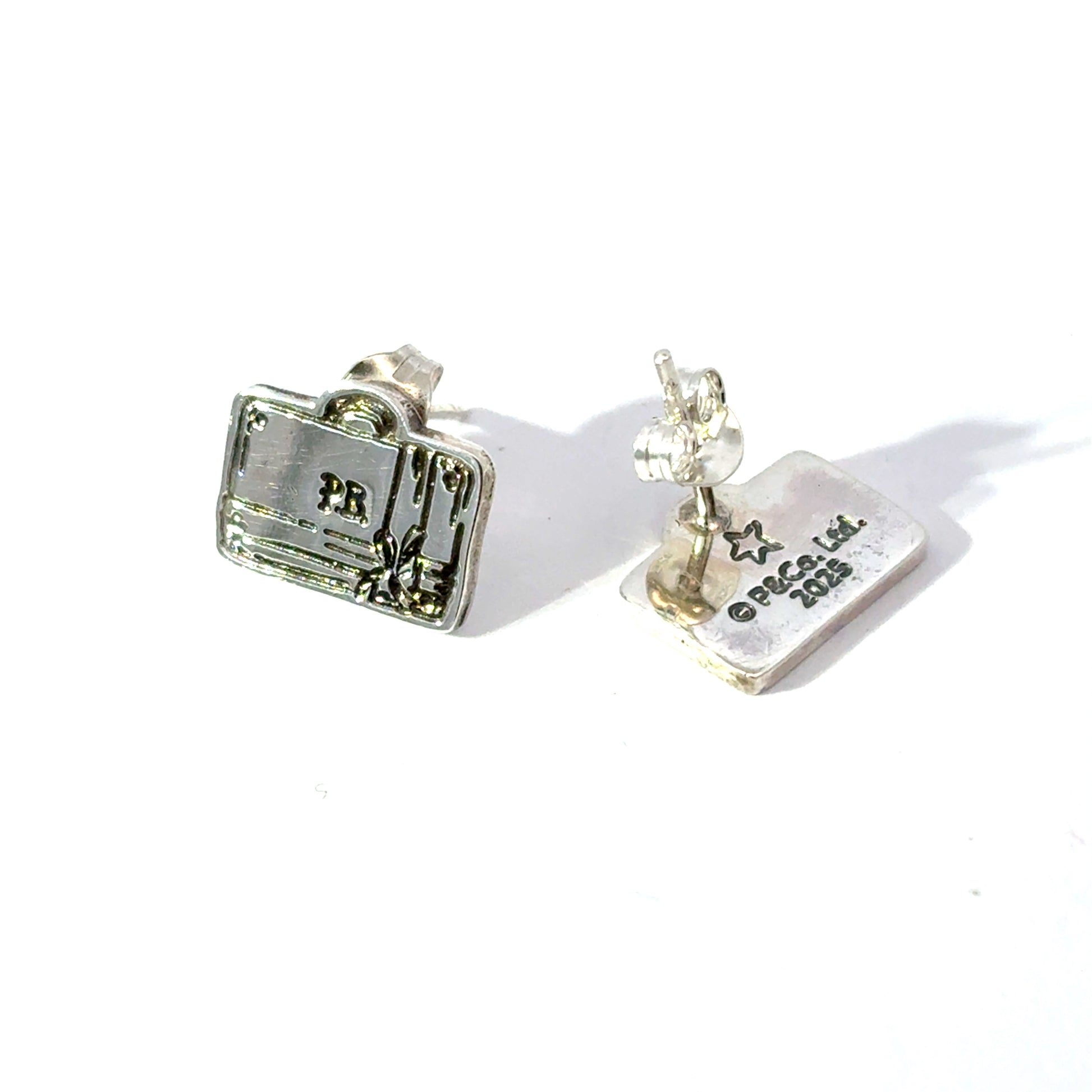 Licensed To Charm sterling silver Paddington luggage stud earrings with bow on white background