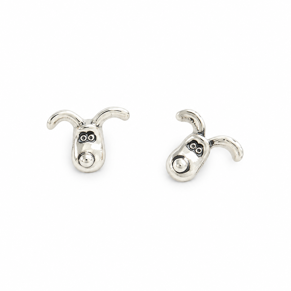 Pair of sterling silver Gromit stud earrings with curved ears and detailed faces, shown on a white background.
