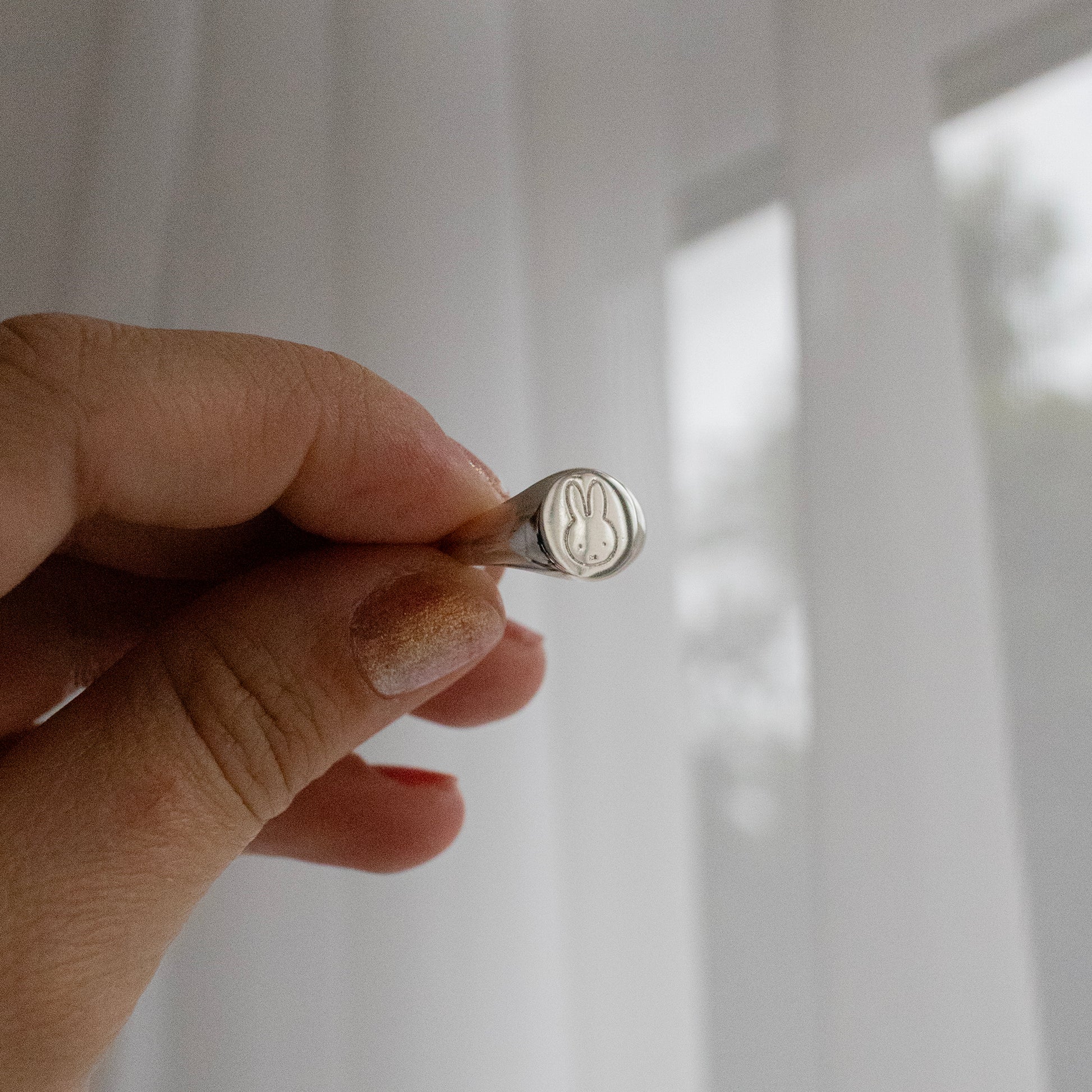 Licensed To Charm Miffy Signet Adjustable Ring in sterling silver, showcasing Miffy’s silhouette holding in hand. A delightful accessory for fans of all ages