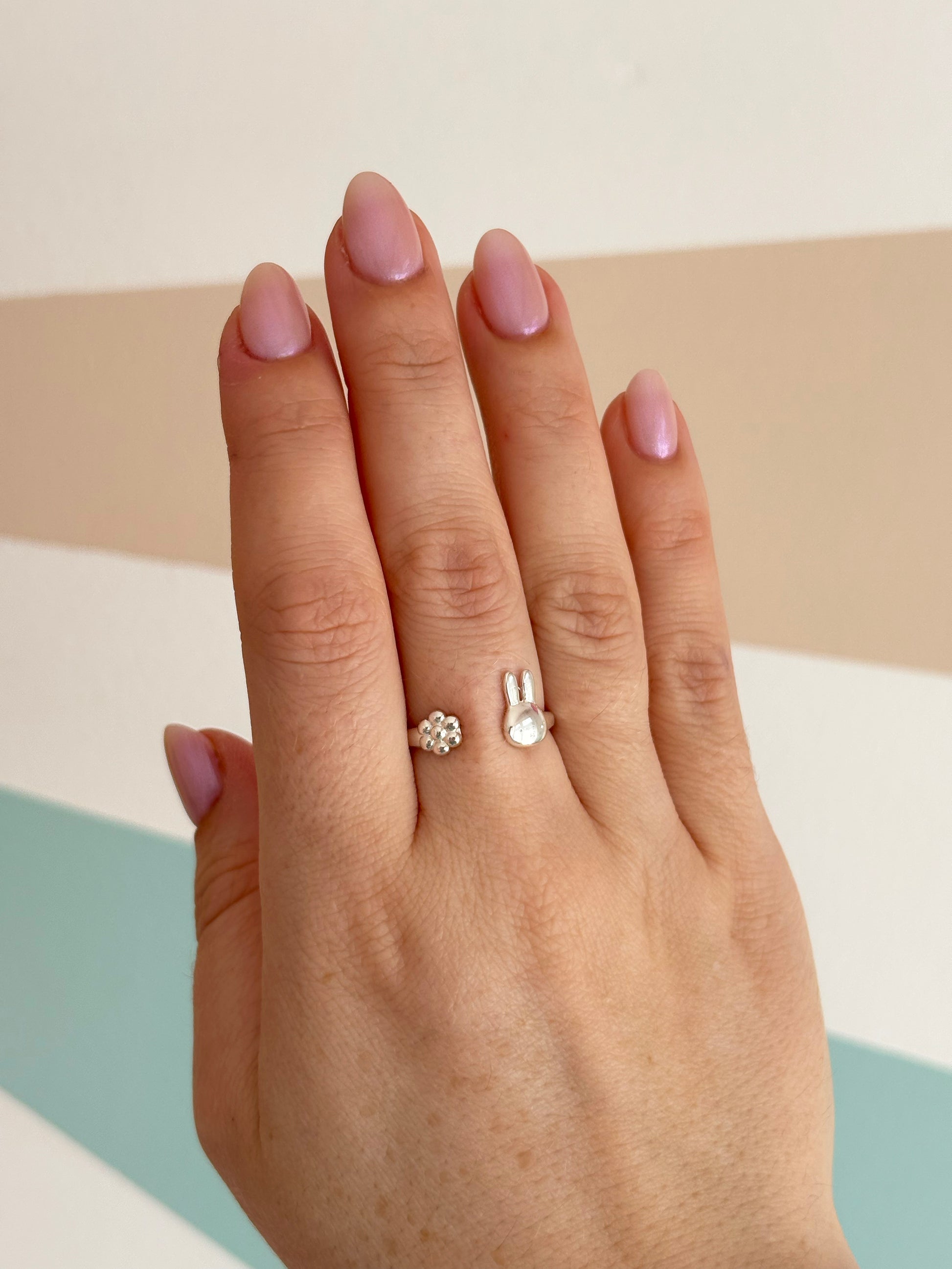 Licensed To Charm Hand wearing Miffy ring on a neutral background