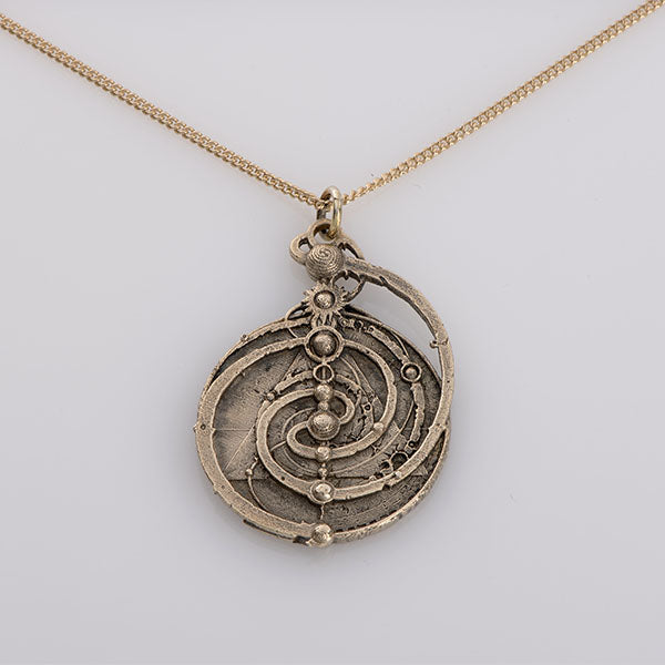 Licensed To Charm Dark Crystal A brass mandala-shaped necklace with a golden chain.