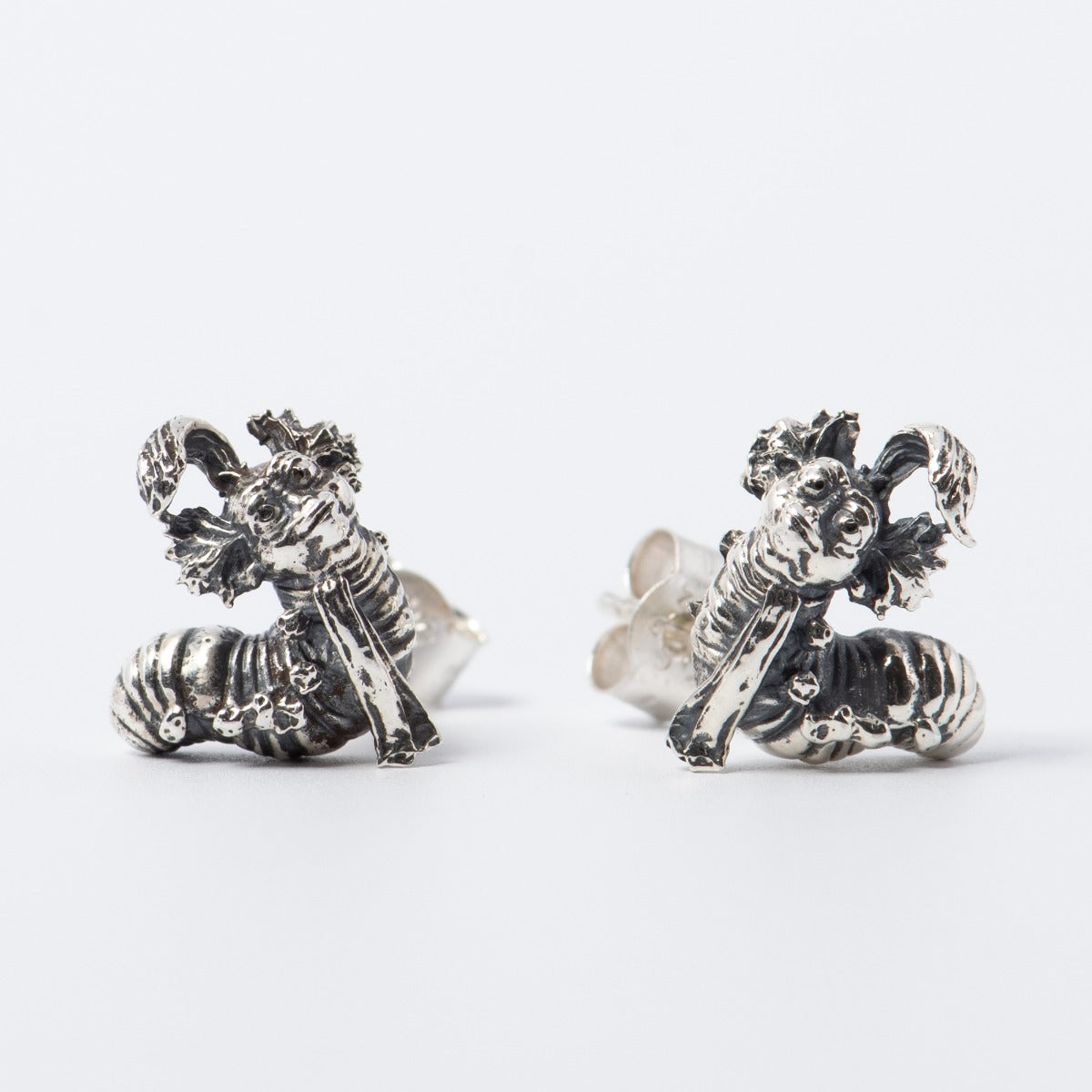 Licensed To Charm Labyrinth Worm Stud Earrings in sterling silver. Features the charming and quirky Worm character from Jim Henson’s Labyrinth, intricately handcrafted with secure stud backs. Playful and eco-friendly, perfect for daily wear.