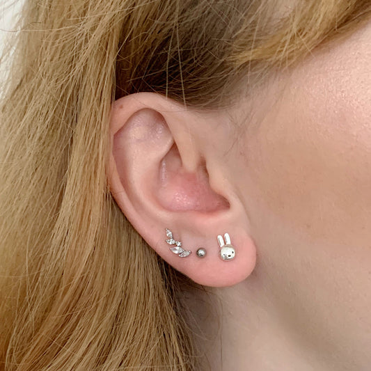 Licensed To Charm Miffy Mini Head sterling silver stud earrings worn on ear, dainty everyday Miffy jewellery.
