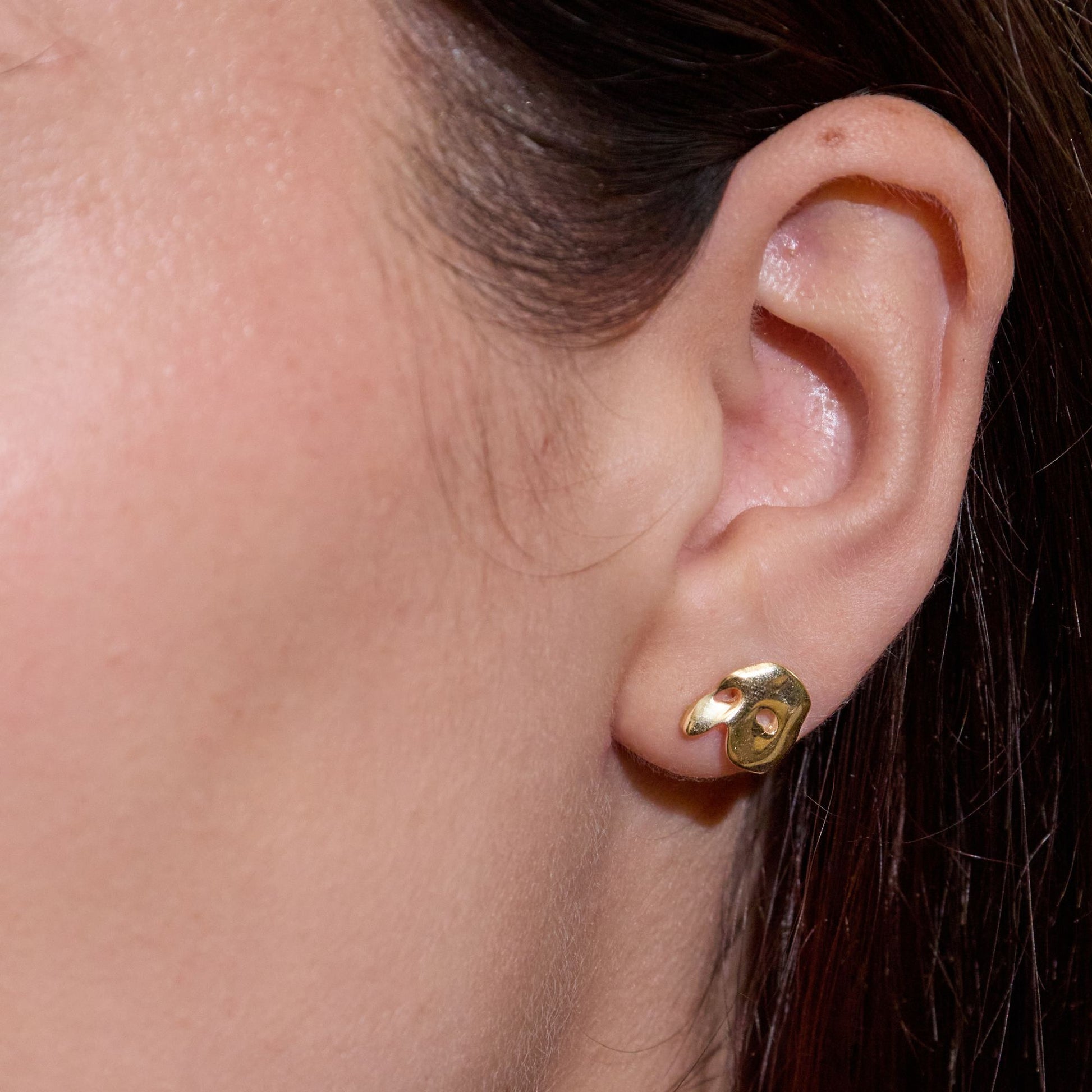Licensed To Charm Model wearing Phantom of the opera gold stud earrings, elegant everyday style
