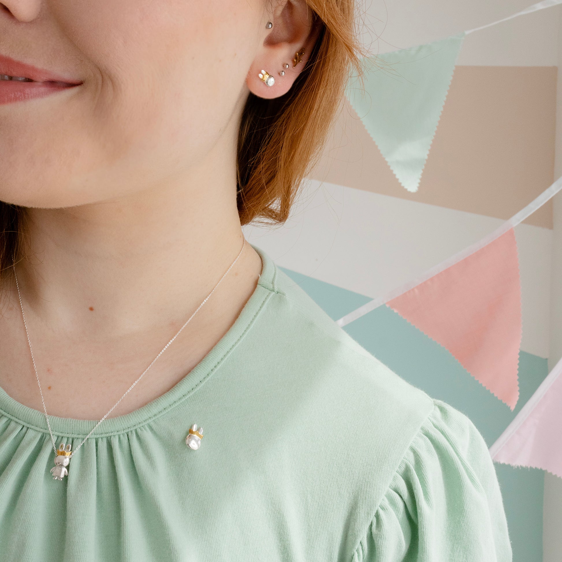 Licensed To Charm Close-up of Queen Miffy earrings featuring her iconic face and gold-plated crown.
