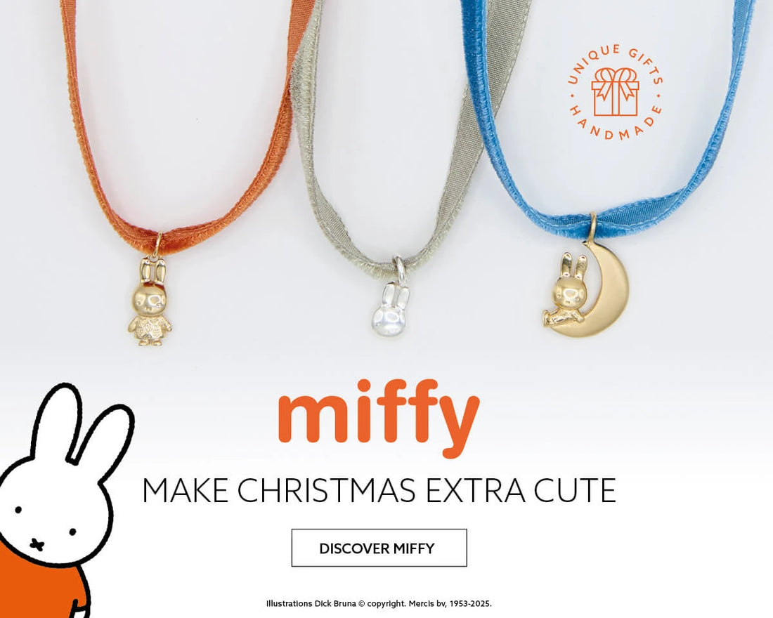 Miffy Christmas jewellery banner featuring gold and silver Miffy charms on velvet ribbons with illustration of Miffy sitting on a moon. Text reads ‘Make Christmas Extra Cute’. Licensed To Charm