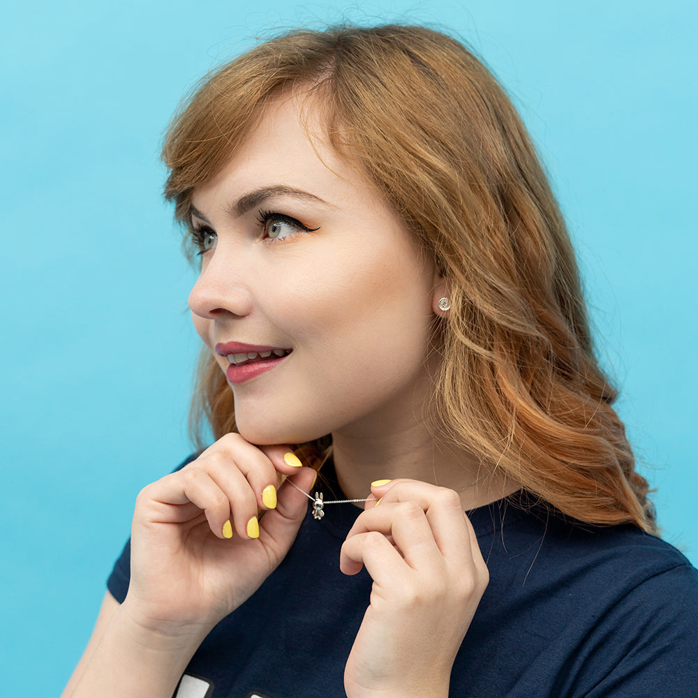 Miffy Daisy Charm Necklace displayed on a neckline, highlighting the intricate daisy pattern and playful, movable Miffy charm.