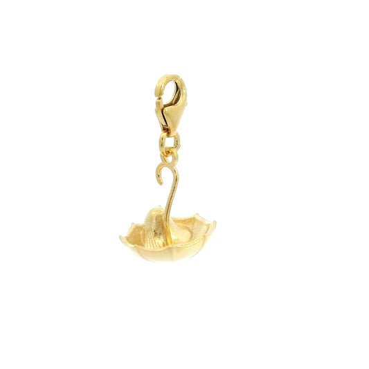 Close-up of gold Nibling charm peeking out from under umbrella