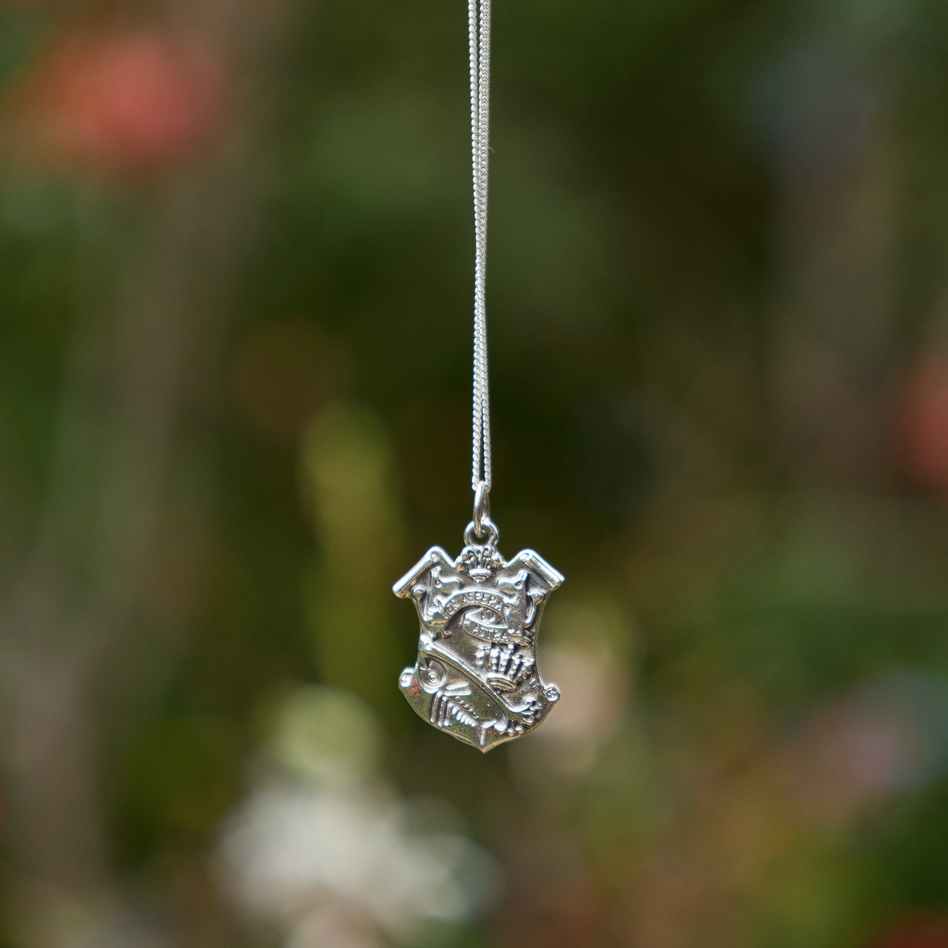 Licensed To Charm Sterling Silver Moomin pendant necklace against a blurred natural background