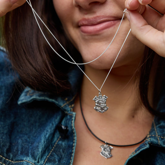 Licensed To Charm Moomin silver necklace model holding pendant close to their face