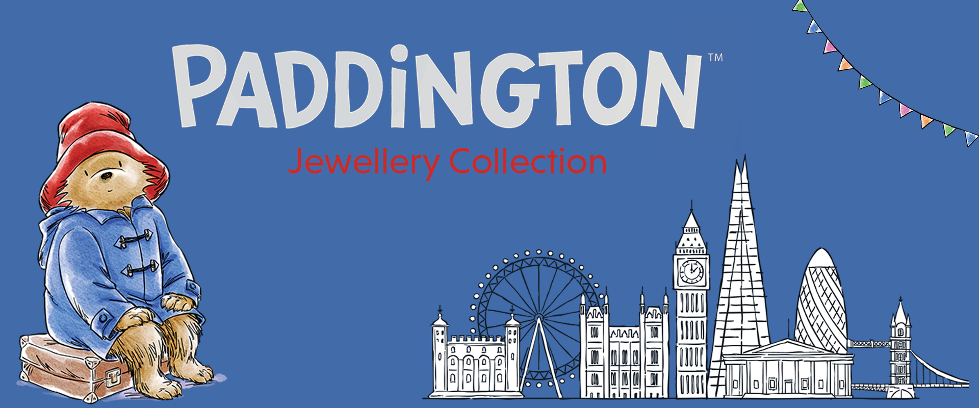 Paddington Bear with a suitcase on a blue background featuring London landmarks and 'Paddington Jewellery Collection' text.