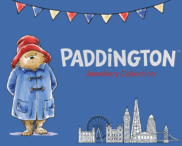 Paddington Bear with a suitcase on a blue background featuring London landmarks and 'Paddington Jewellery Collection' text.