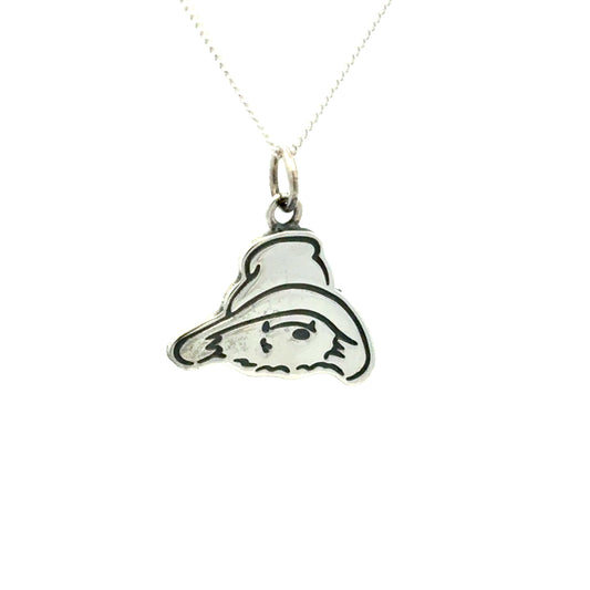 Silver pendant shaped like Paddington bear on a white background