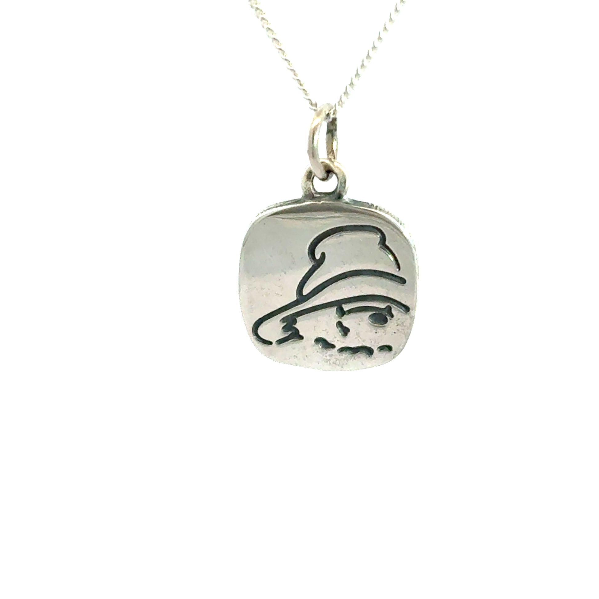 Sterling silver necklace featuring a square pendant with etched Paddington Bear face on a white background