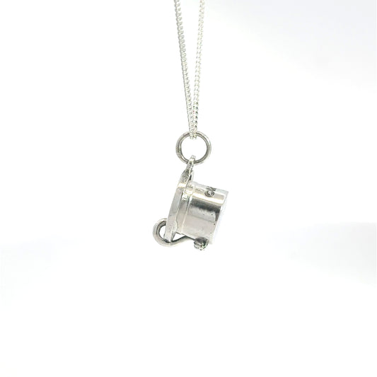 Close-up of handcrafted sterling silver Moomin top hat charm necklace.