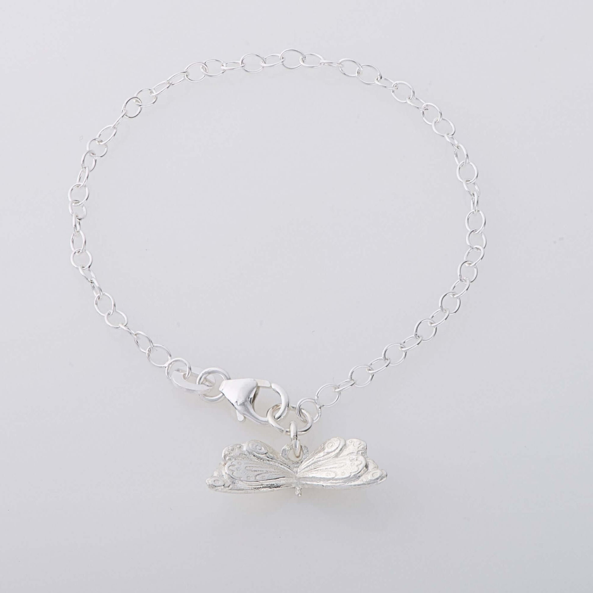 Sterling silver butterfly charm bracelet inspired by The Very Hungry Caterpillar, handcrafted in the UK. A whimsical jewellery gift for all ages.