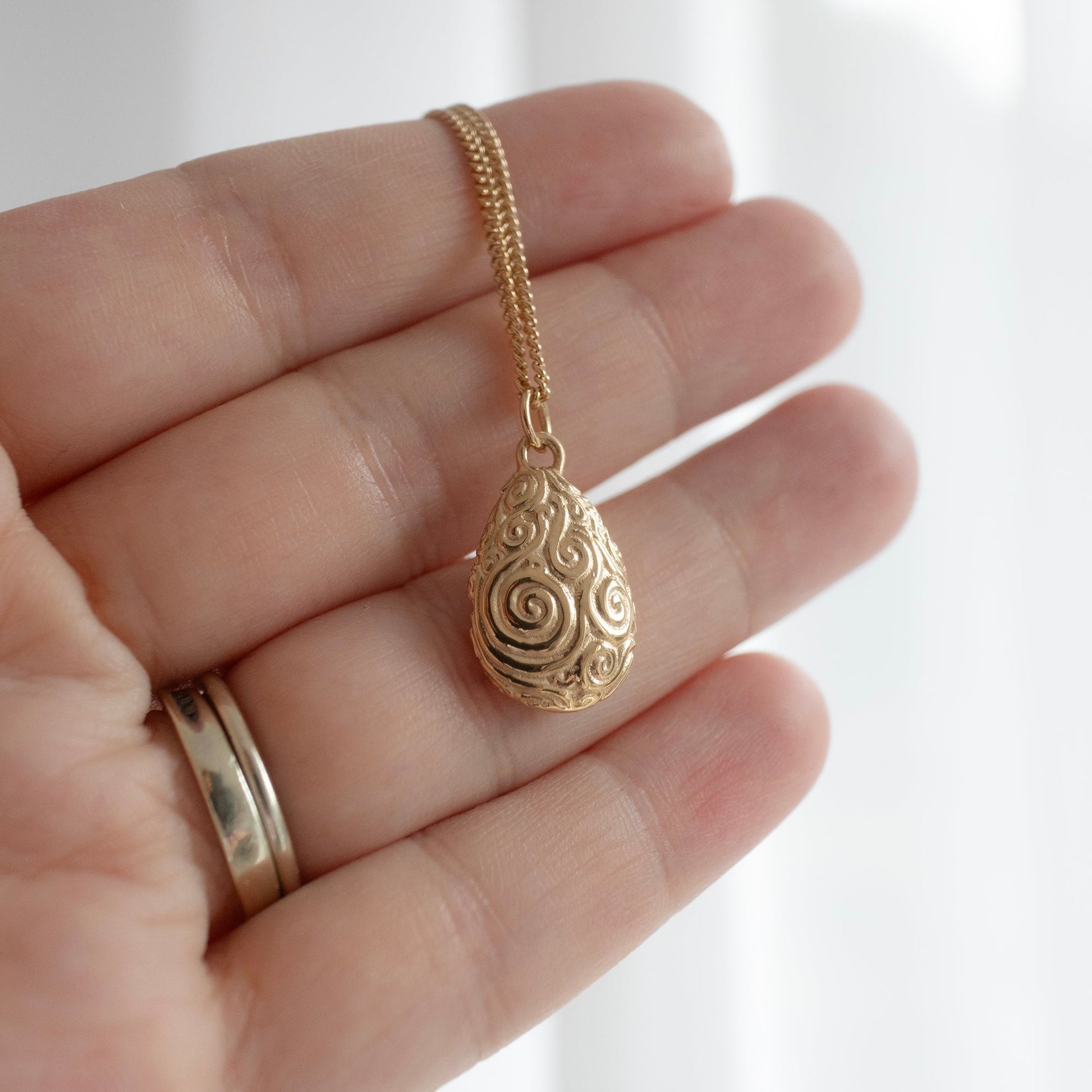 Handcrafted 18ct gold vermeil Mystic Valley Pebble Necklace, inspired by the sacred valley of the urRu in The Dark Crystal. Etched with spiral designs, capturing the wisdom and harmony of the Mystics