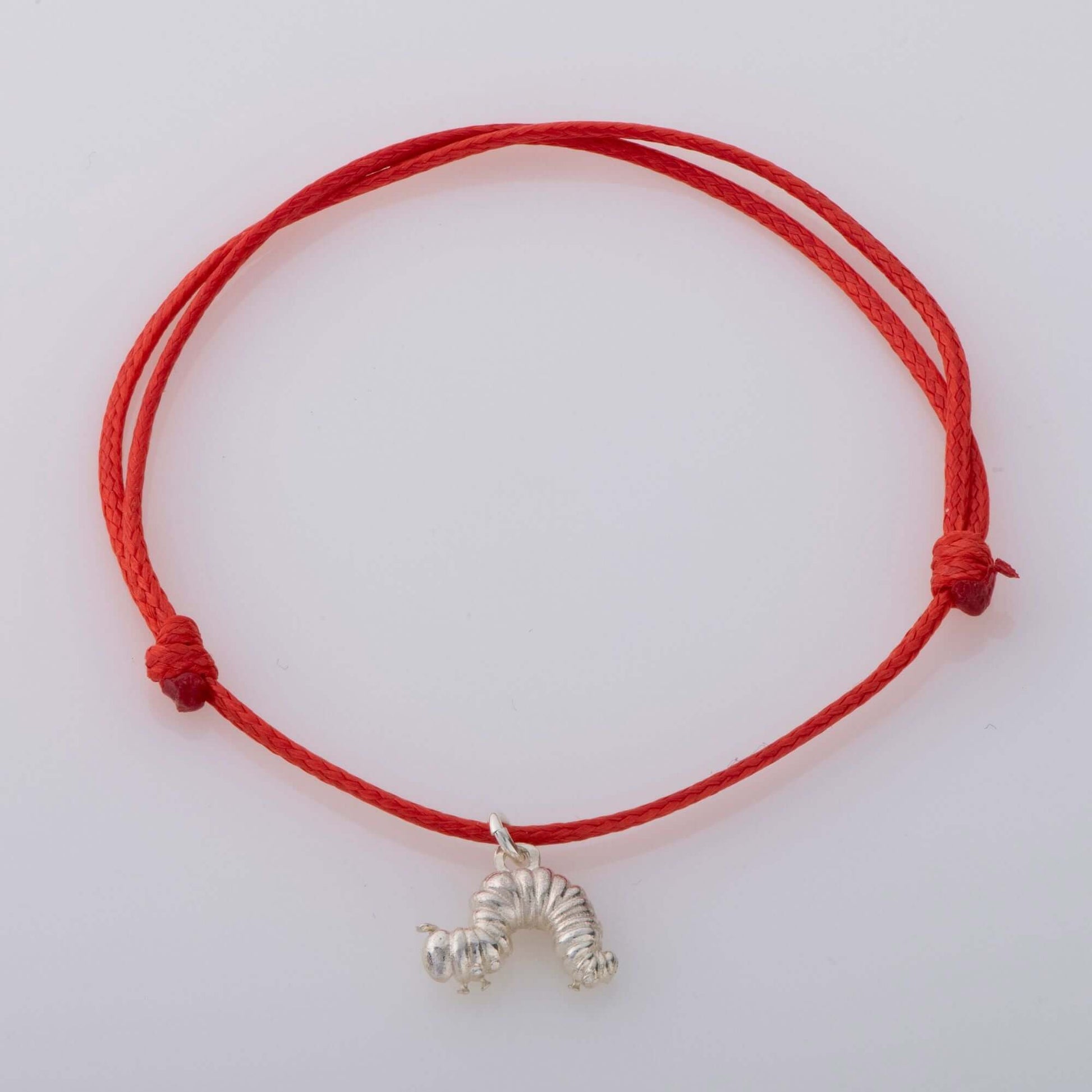 Celebrate childhood nostalgia with The Very Hungry Caterpillar Children's Bracelet. Handmade in the UK with recycled sterling silver and an adjustable red cord.