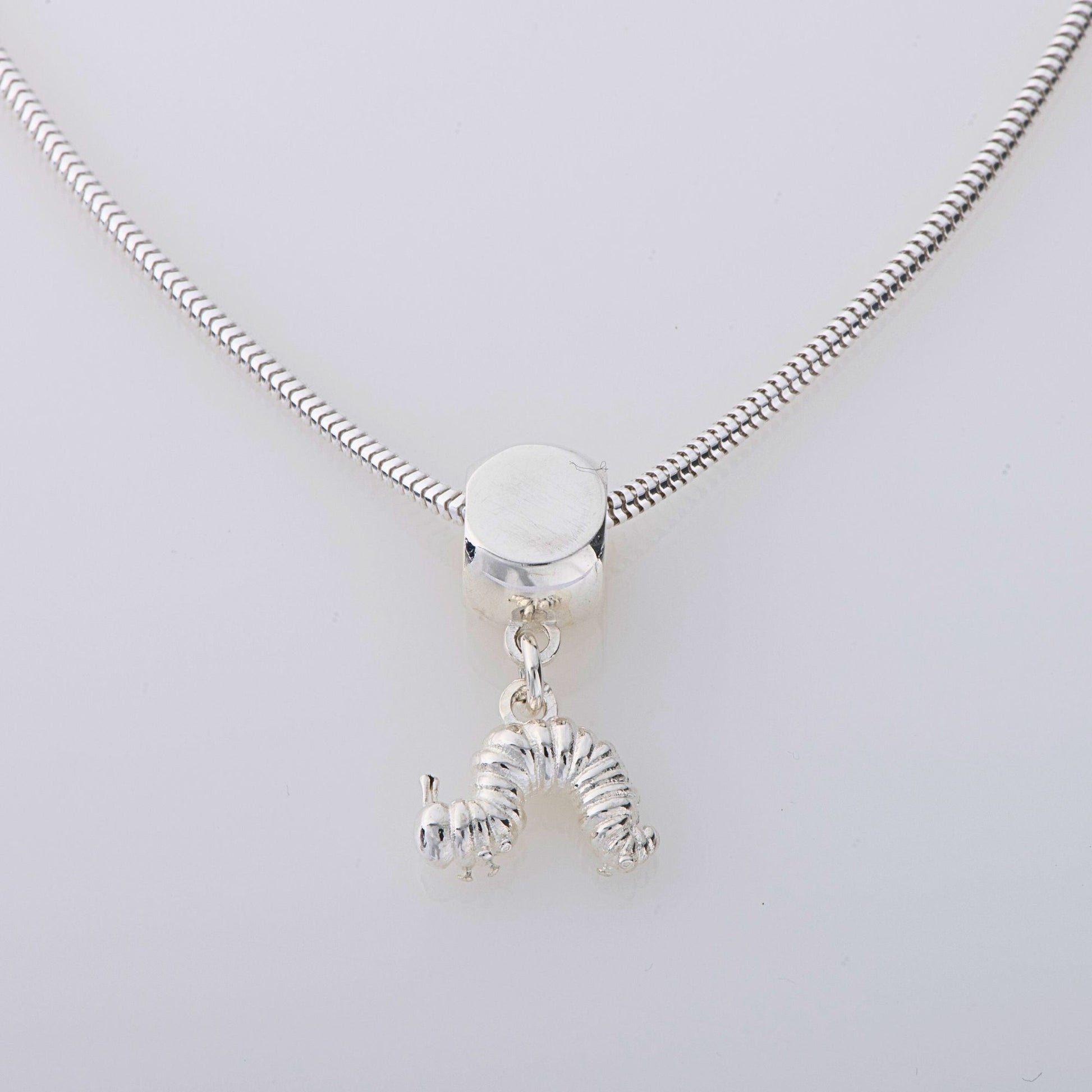 Handmade Very Hungry Caterpillar Dangle Necklace in sterling silver, featuring an intricately detailed caterpillar charm inspired by Eric Carle’s classic book. A fun jewellery gift for all ages.