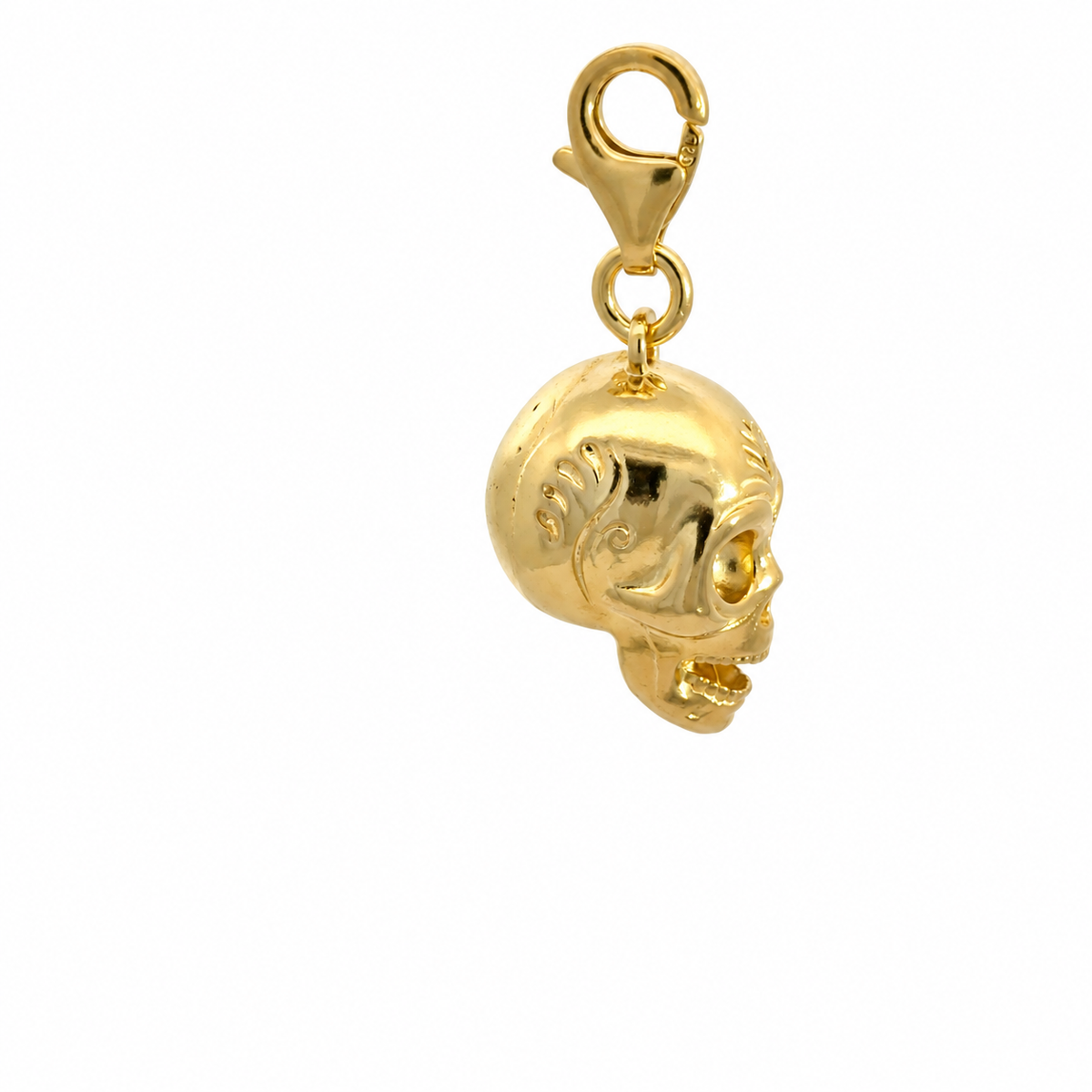 Side view of the Frida Kahlo Calavera Skull Charm in 18ct gold vermeil, showing engraved scroll detail and an open smiling jaw.