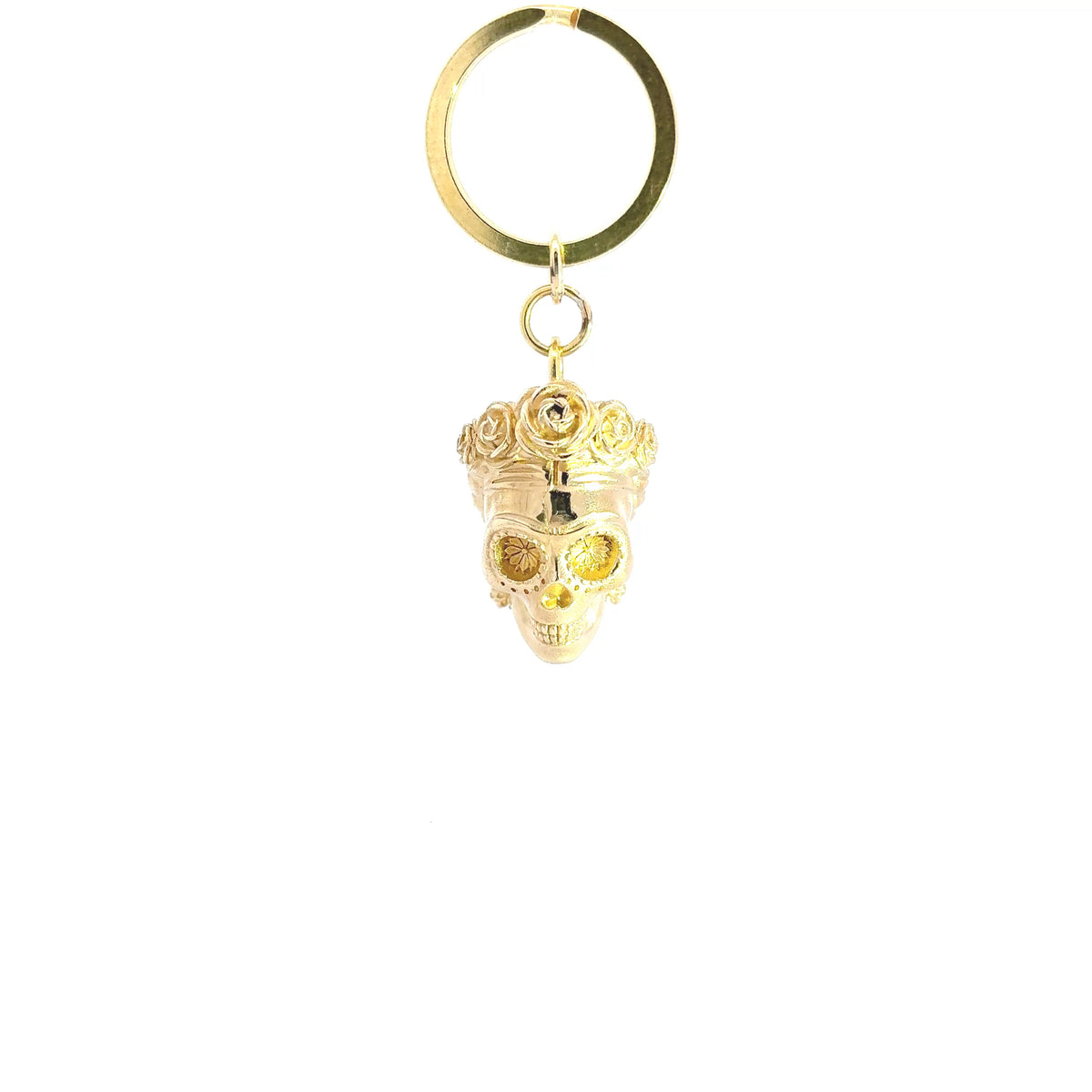 A brass metal keychain featuring a Frida Kahlo as sugar skull pendant adorned with a crown and a small rhinestone, attached to a split key ring against a plain white background.