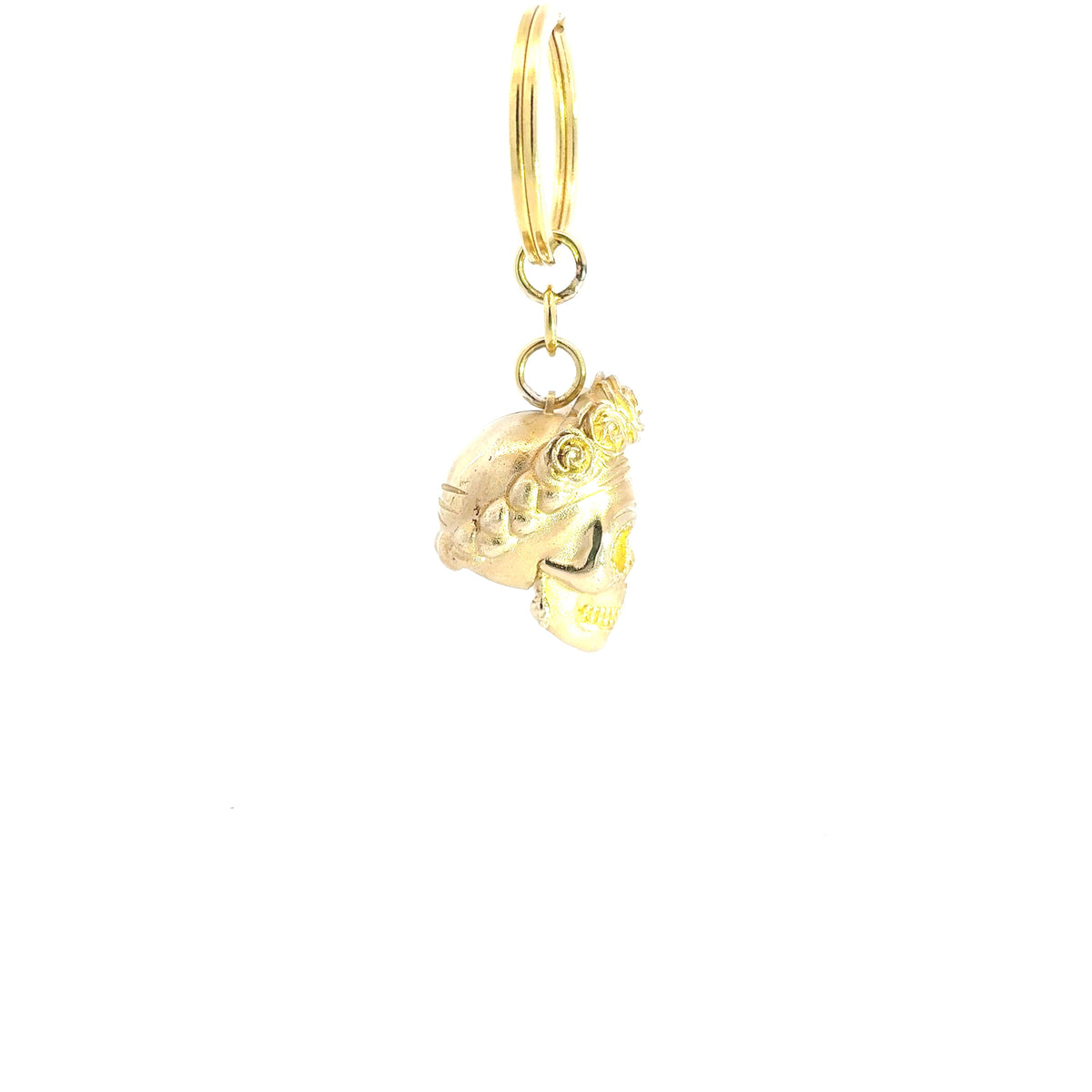 A Frida Kahlo skull brass keyring and bag charm handmade in the UK with a crown of roses, attached to a split ring and loop, shown on a plain white background.