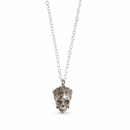 Sterling silver Frida Kahlo-inspired sugar skull necklace with floral headpiece on a clean white background.