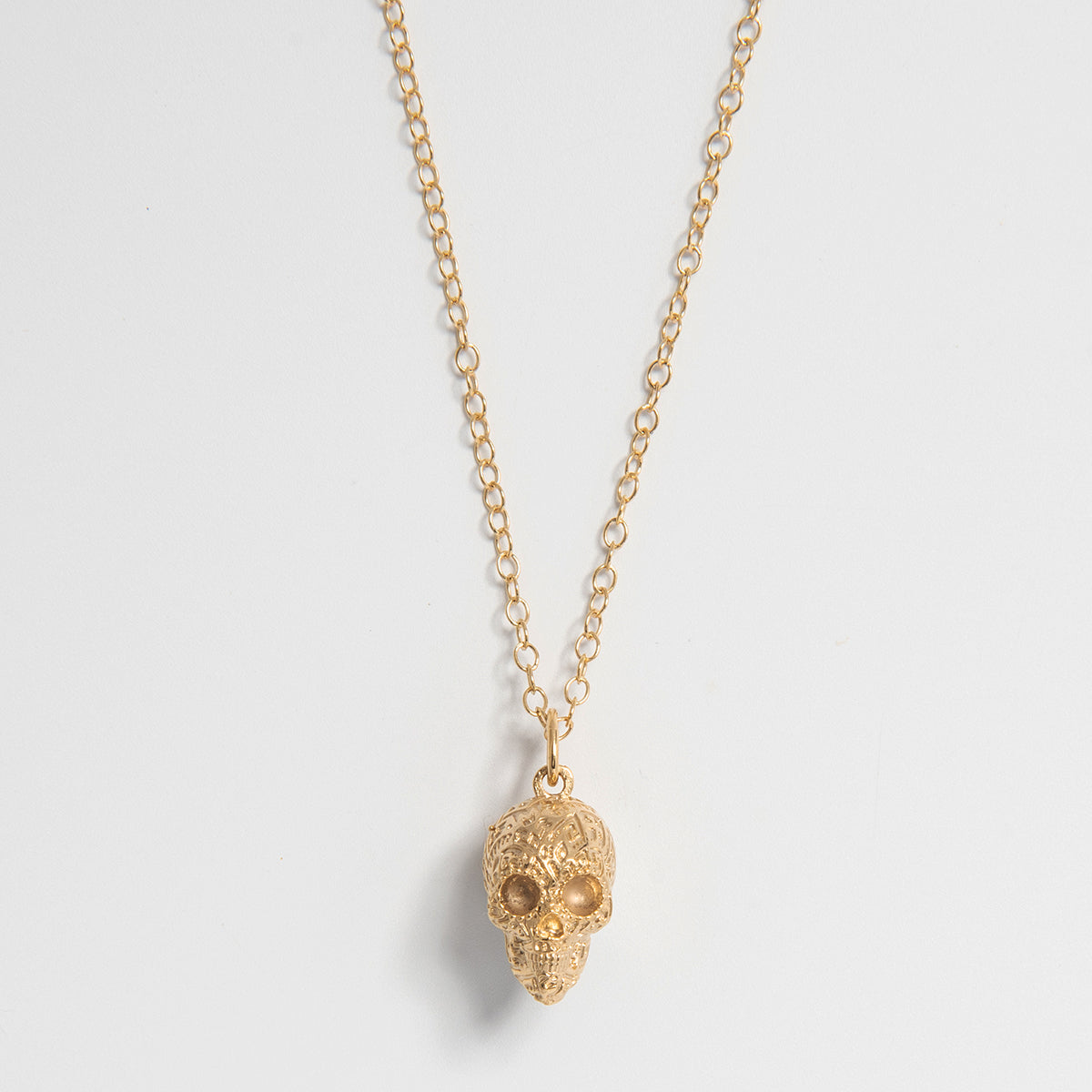 Frida Kahlo Aztec Skull Charm Necklace in sterling silver plated in 18ct Gold Vermeil, inspired by traditional Mexican iconography. Handmade in the UK, perfect for necklaces or charm bracelets