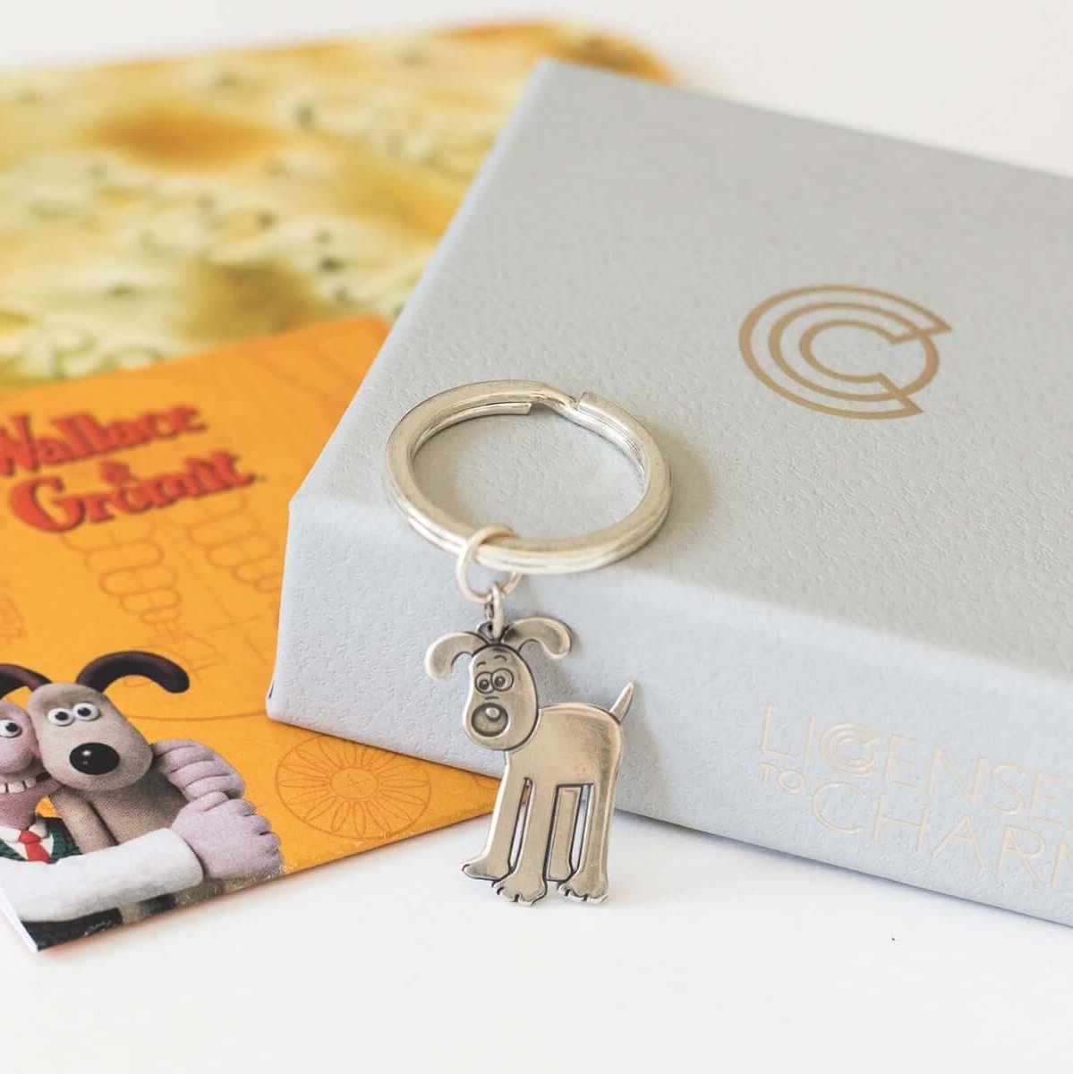 Licensed to Charm Standing Gromit sterling silver keyring displayed on a grey gift box