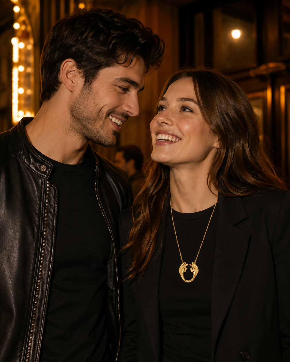 Gold plated Jesus Christ Superstar large pendant necklace worn by a woman on a theatre night out with a stylish couple in black outfits.