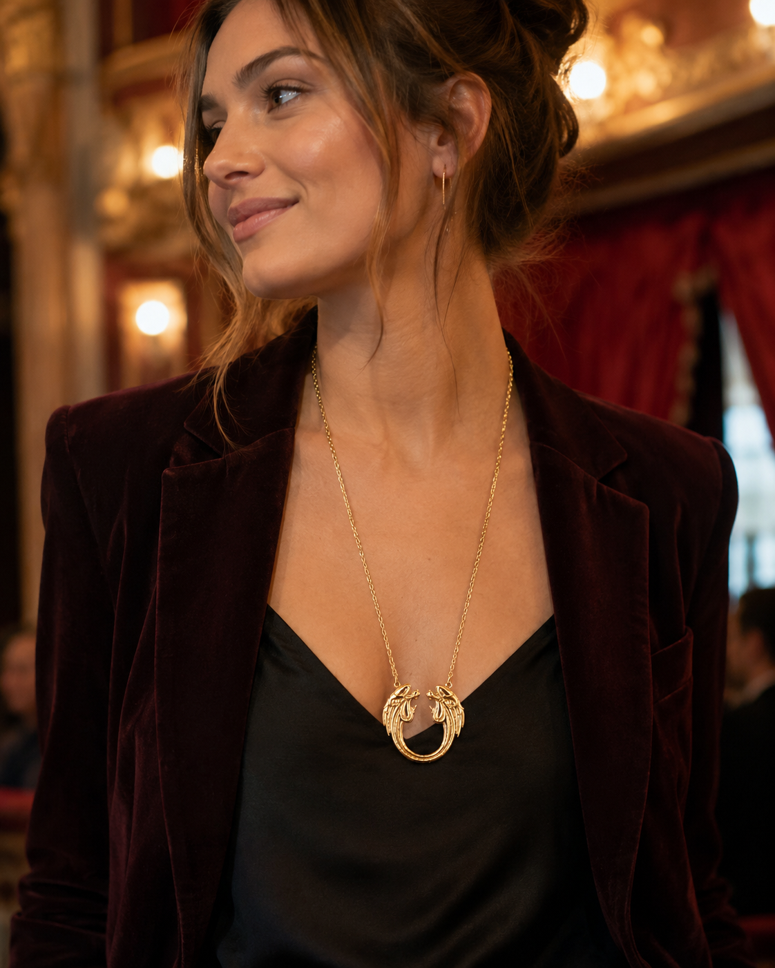Gold plated Jesus Christ Superstar large pendant necklace styled over a black top with a leather jacket for a modern theatre night look.