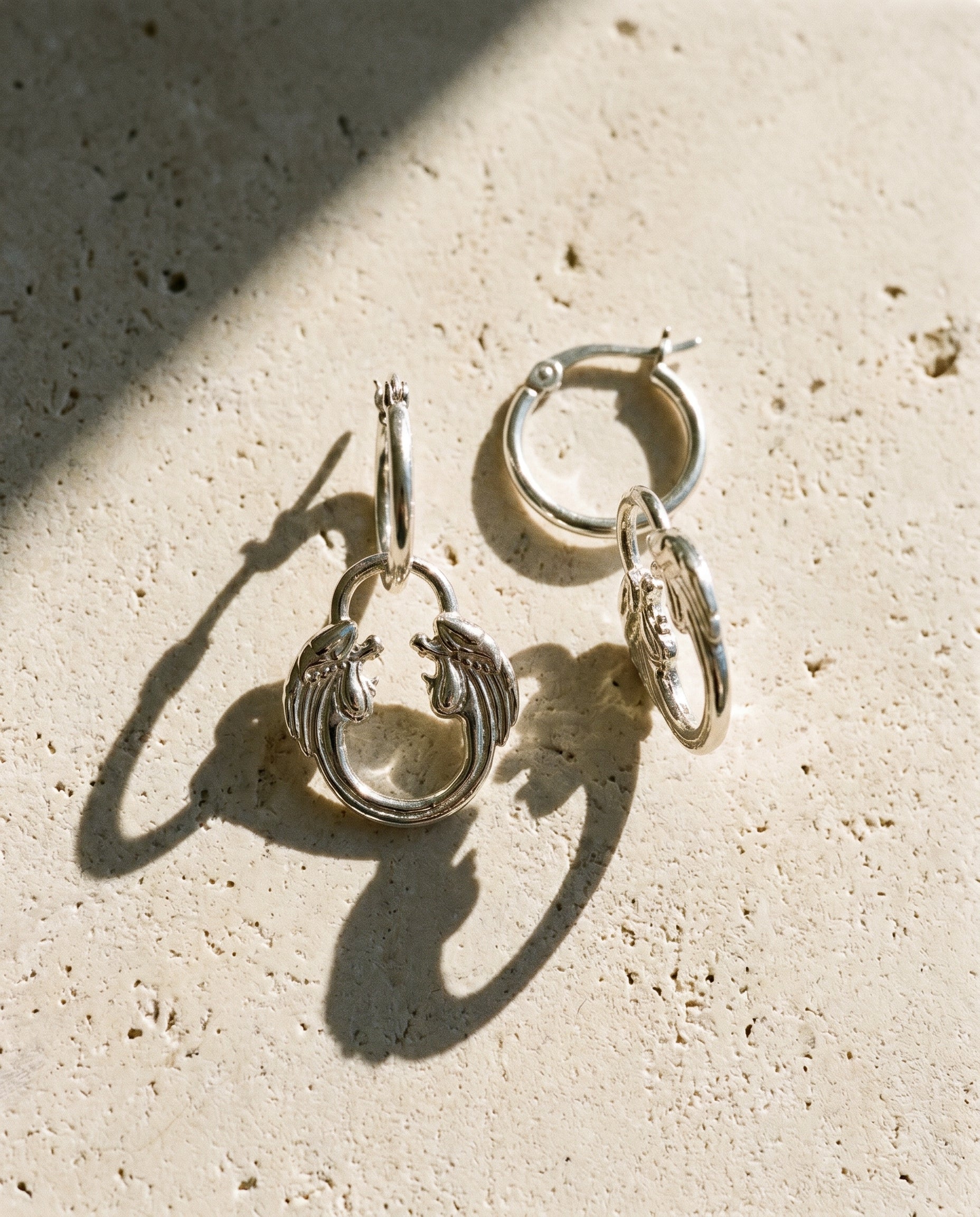 Jesus Christ Superstar silver jewellery collection featuring hoop earrings and necklace, official Andrew Lloyd Webber gifts.