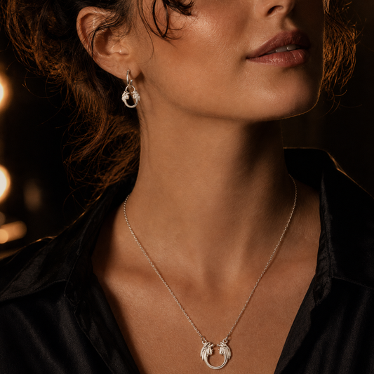 Model wearing Jesus Christ Superstar sterling silver necklace, a meaningful Andrew Lloyd Webber gift for theatre fans.