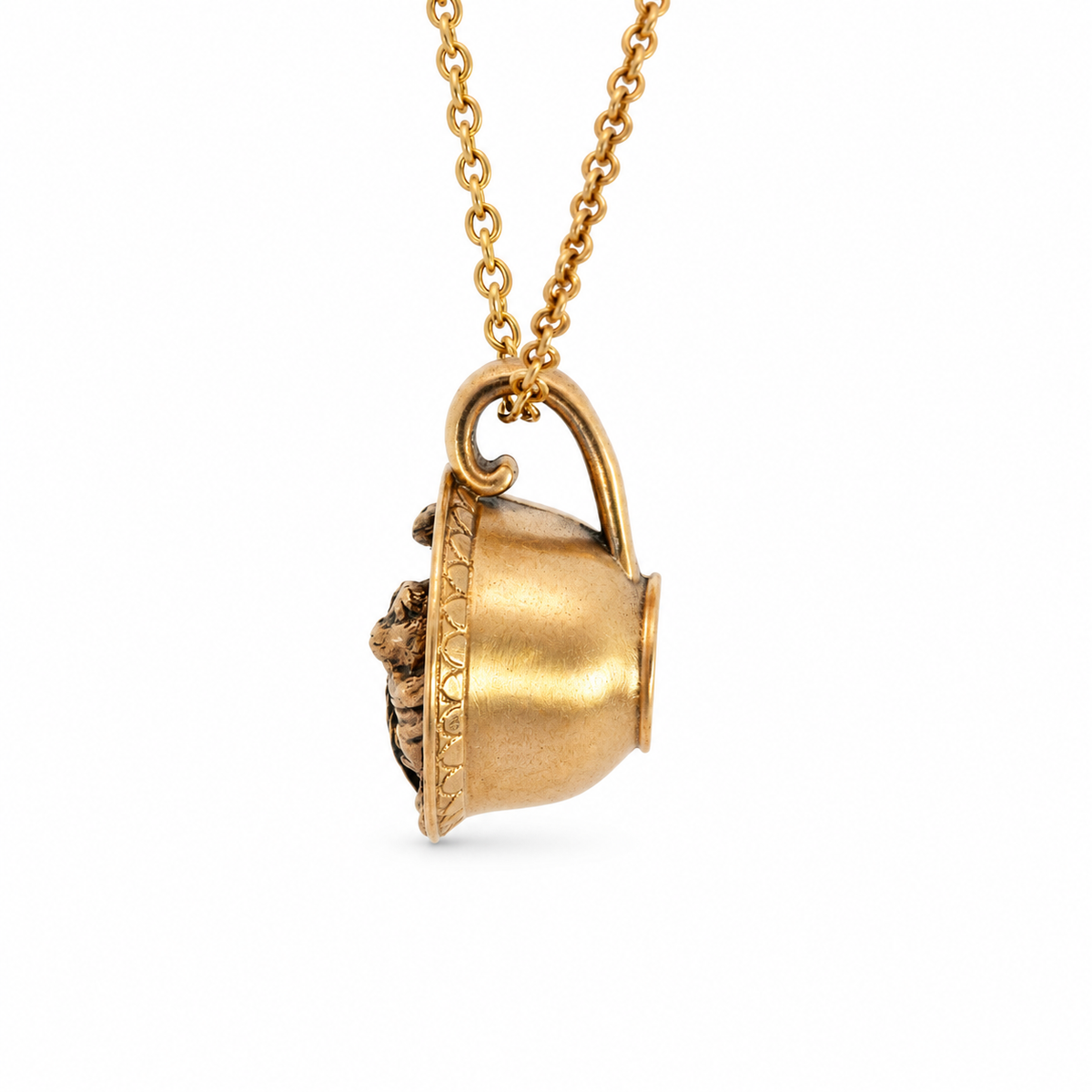 Side view showing the sculpted detail of the Labyrinth Worm in a Cup bronze necklace