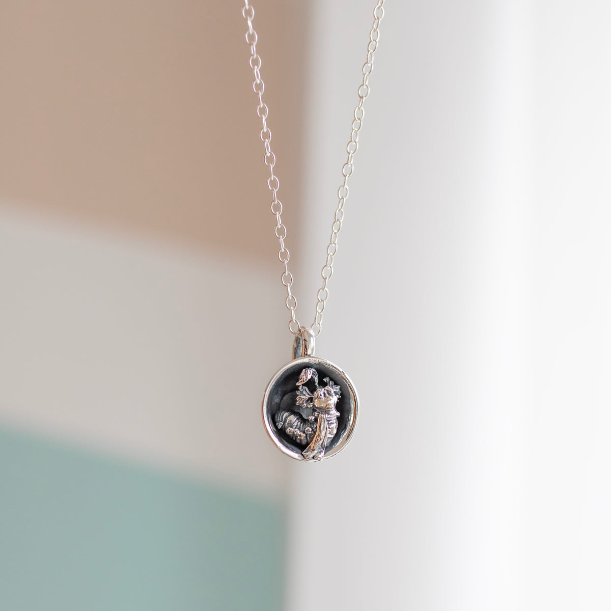 Labyrinth Worm in a Cup sterling silver necklace showing the detailed pendant