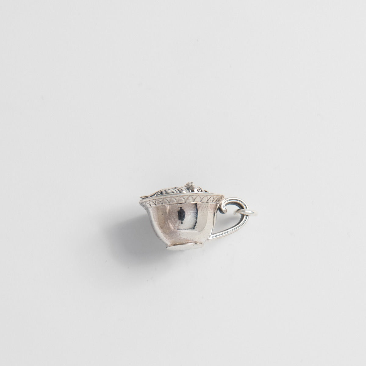 Side view of the Labyrinth Worm in a Cup sterling silver pendant