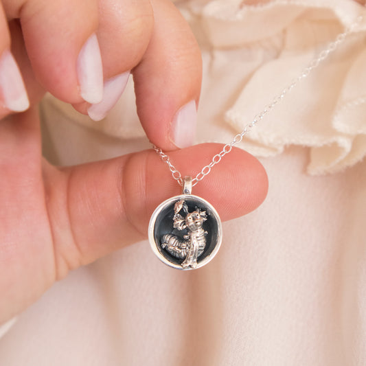 Labyrinth movie jewellery – Sterling Silver Worm in a Cup Necklace. A whimsical design showcasing the charming Worm character in a cosy teacup, handmade in the UK from recycled sterling silver. Comes with a 45 cm chain.